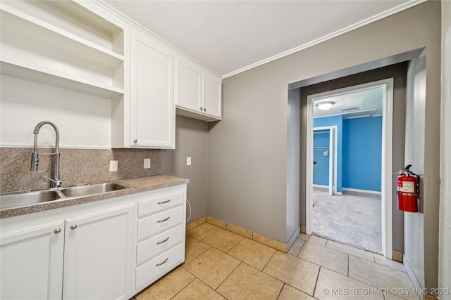 1448 S Darlington Ave, Tulsa, OK 74112 - kitchen with open shelves, white cabinets, ornamental molding, light tile patterned floors, and decorative backsplash
