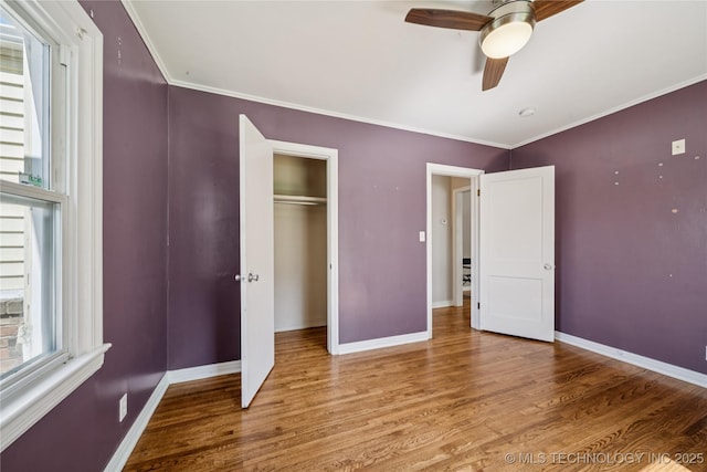1448 S Darlington Ave, Tulsa, OK 74112 - unfurnished bedroom featuring wood finished floors, crown molding, a closet, and a ceiling fan
