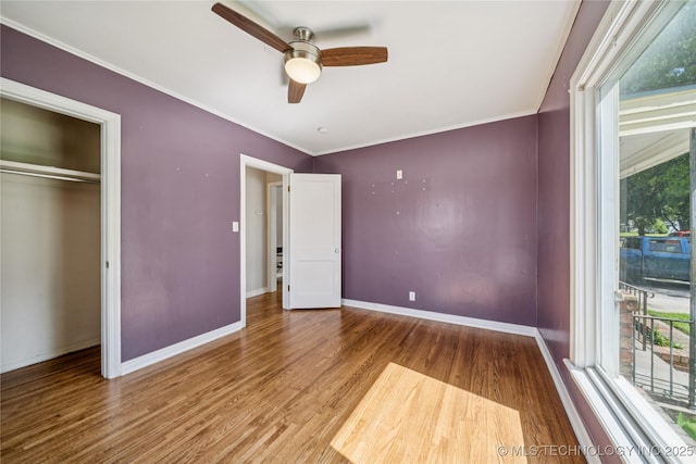 1448 S Darlington Ave, Tulsa, OK 74112 - unfurnished bedroom with wood finished floors, crown molding, ceiling fan, and a closet