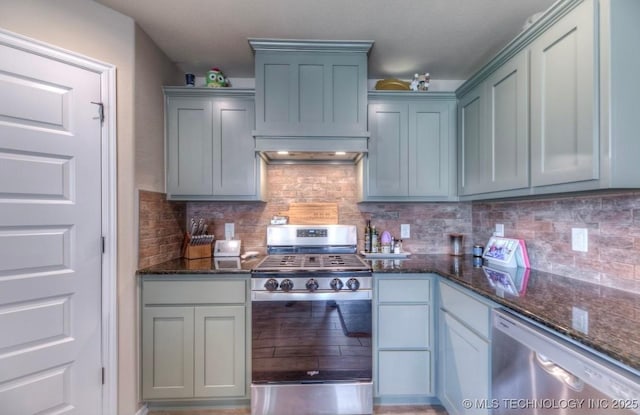 12005 E 108th Pl N, Owasso, OK 74055 - kitchen with stainless steel appliances, dark stone counters, and tasteful backsplash