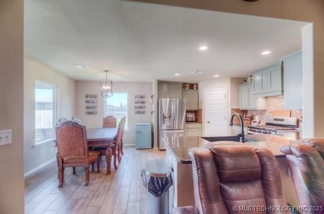 12005 E 108th Pl N, Owasso, OK 74055 - dining area featuring a chandelier, light wood-type flooring, and recessed lighting