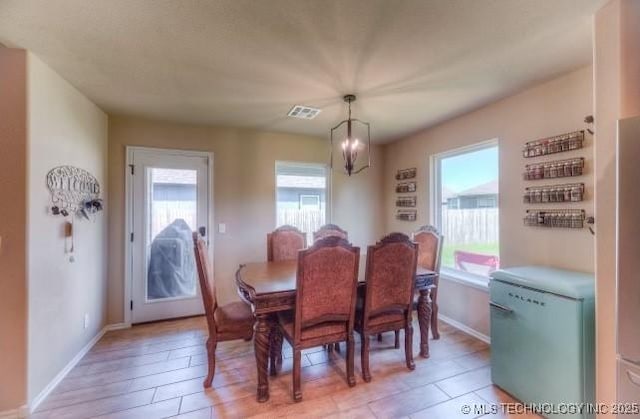12005 E 108th Pl N, Owasso, OK 74055 - dining area featuring light tile patterned flooring and a chandelier