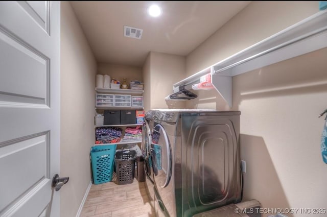 12005 E 108th Pl N, Owasso, OK 74055 - laundry room with washer and dryer and wood finished floors