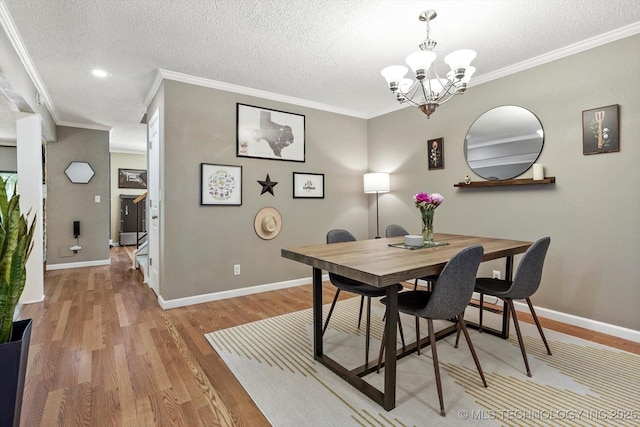 2955 E 84th St S Unit 65, Tulsa, OK 74137 - dining area with a chandelier, light wood-style flooring, ornamental molding, and a textured ceiling