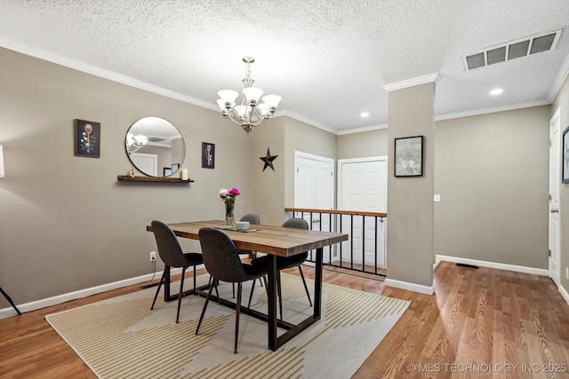 2955 E 84th St S Unit 65, Tulsa, OK 74137 - dining room with a chandelier, wood finished floors, a textured ceiling, recessed lighting, and ornamental molding