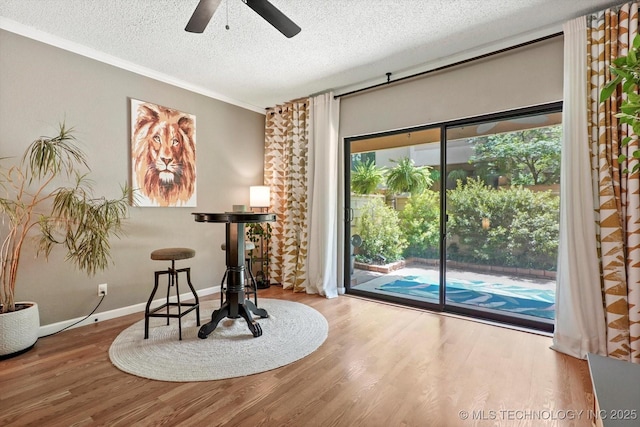 2955 E 84th St S Unit 65, Tulsa, OK 74137 - dining area featuring a textured ceiling, wood finished floors, a ceiling fan, plenty of natural light, and crown molding