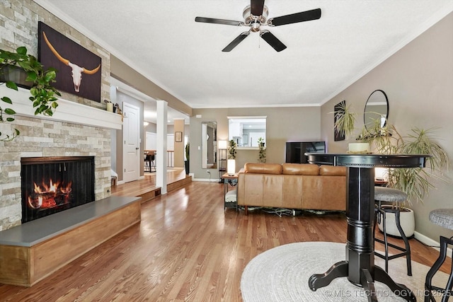 2955 E 84th St S Unit 65, Tulsa, OK 74137 - living room with ceiling fan, wood finished floors, a fireplace, and crown molding
