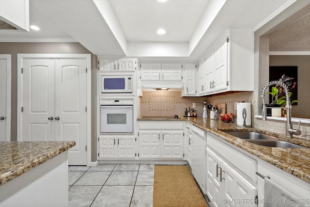 2955 E 84th St S Unit 65, Tulsa, OK 74137 - kitchen featuring white appliances, ornamental molding, light stone countertops, white cabinetry, and recessed lighting