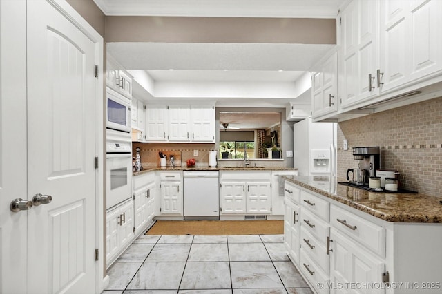 2955 E 84th St S Unit 65, Tulsa, OK 74137 - kitchen with white appliances, decorative backsplash, and white cabinets