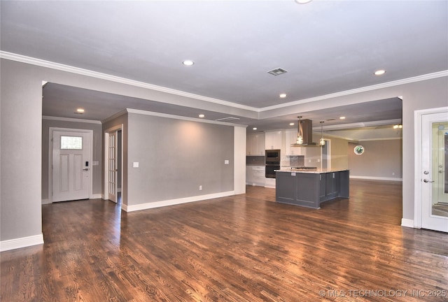 7020 E 89th St, Tulsa, OK 74133 - unfurnished living room featuring crown molding, dark wood-style floors, and recessed lighting