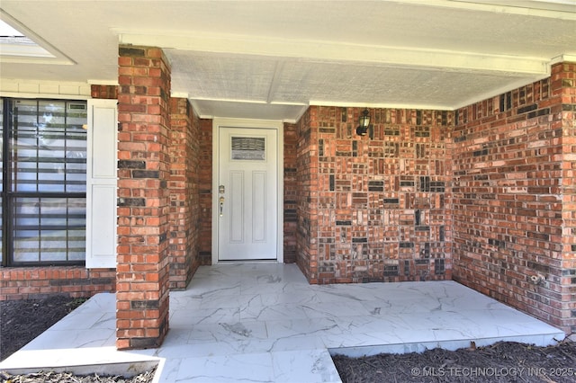 7020 E 89th St, Tulsa, OK 74133 - doorway to property with brick siding and a porch