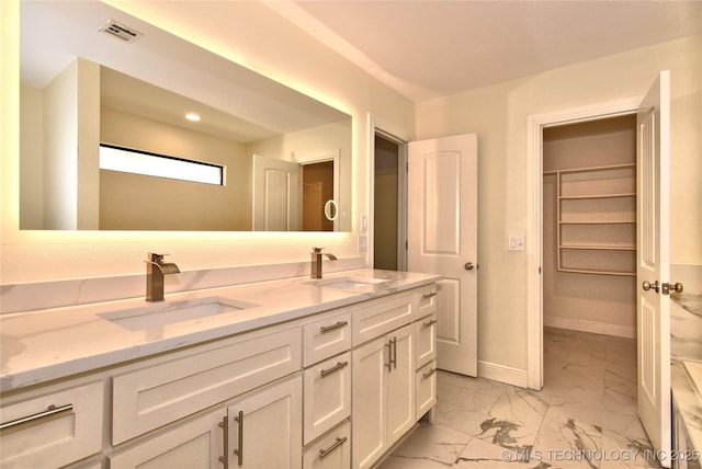7020 E 89th St, Tulsa, OK 74133 - full bathroom with marble finish floors, double vanity, and a walk in closet
