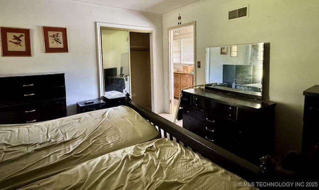 8348 E 7th St S, Tulsa, OK 74112 - bedroom featuring crown molding and a closet