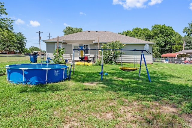 802 NE 9th St, Wagoner, OK 74467 - view of yard with an outdoor pool and a playground