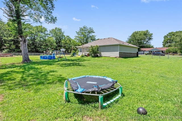 802 NE 9th St, Wagoner, OK 74467 - view of yard with a trampoline
