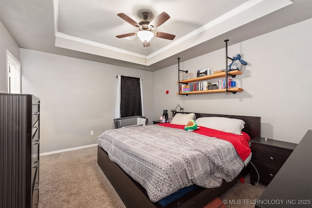 802 NE 9th St, Wagoner, OK 74467 - carpeted bedroom featuring a tray ceiling and a ceiling fan