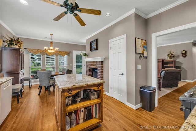 13804 E 90th St, Owasso, OK 74055 - dining area with light wood-type flooring, a brick fireplace, a chandelier, a ceiling fan, and crown molding