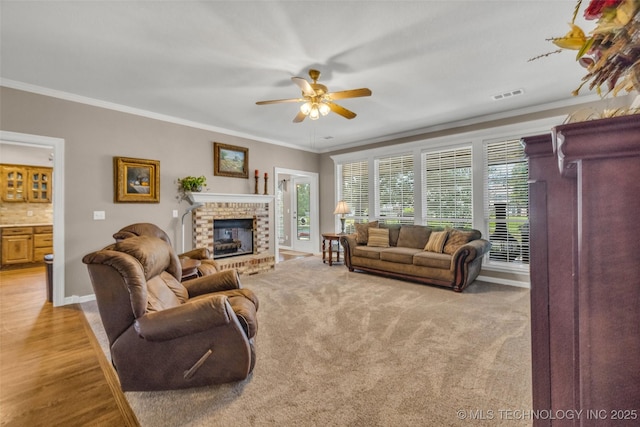 13804 E 90th St, Owasso, OK 74055 - living room featuring a ceiling fan, ornamental molding, and a brick fireplace