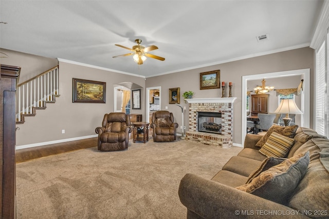13804 E 90th St, Owasso, OK 74055 - living area featuring carpet, a ceiling fan, stairs, arched walkways, and crown molding
