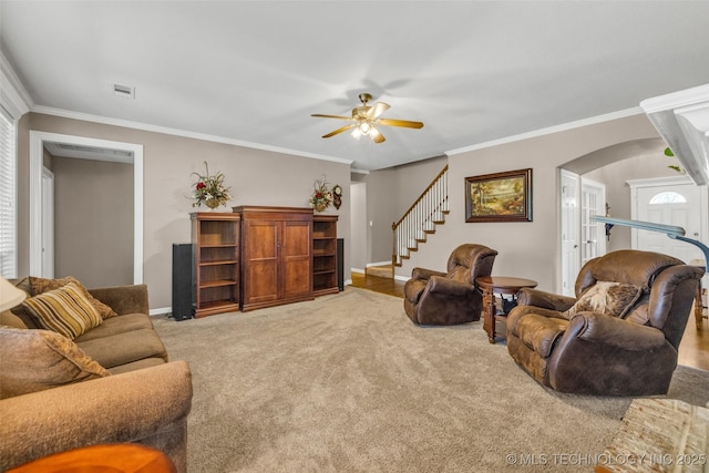 13804 E 90th St, Owasso, OK 74055 - carpeted living room with arched walkways, ceiling fan, crown molding, and stairs