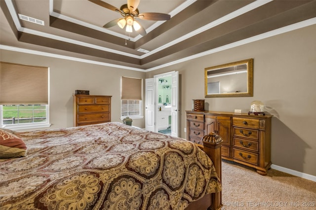13804 E 90th St, Owasso, OK 74055 - bedroom featuring light colored carpet, a tray ceiling, crown molding, ensuite bath, and ceiling fan