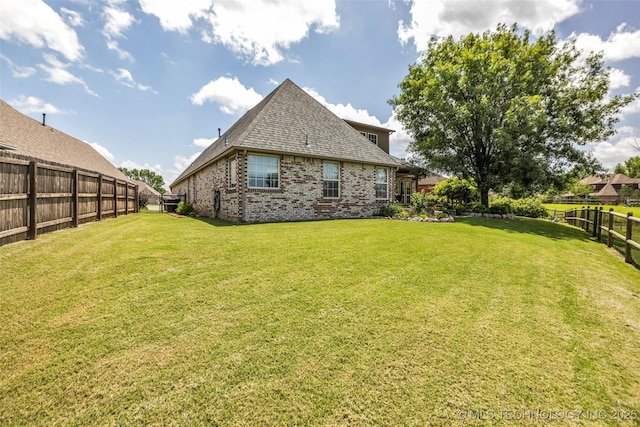 13804 E 90th St, Owasso, OK 74055 - rear view of house featuring a fenced backyard, brick siding, and a shingled roof