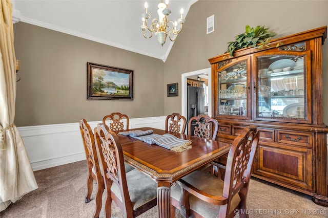 13804 E 90th St, Owasso, OK 74055 - dining room with light carpet, a chandelier, a wainscoted wall, crown molding, and high vaulted ceiling