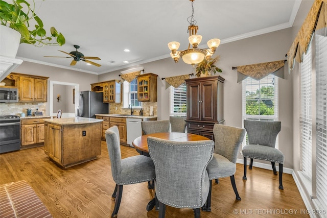 13804 E 90th St, Owasso, OK 74055 - dining room featuring recessed lighting, light wood-type flooring, a ceiling fan, crown molding, and a chandelier