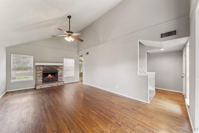 8973 N Crestwood Dr, Sperry, OK 74073 - unfurnished living room featuring a ceiling fan, wood finished floors, vaulted ceiling, a fireplace, and stairs