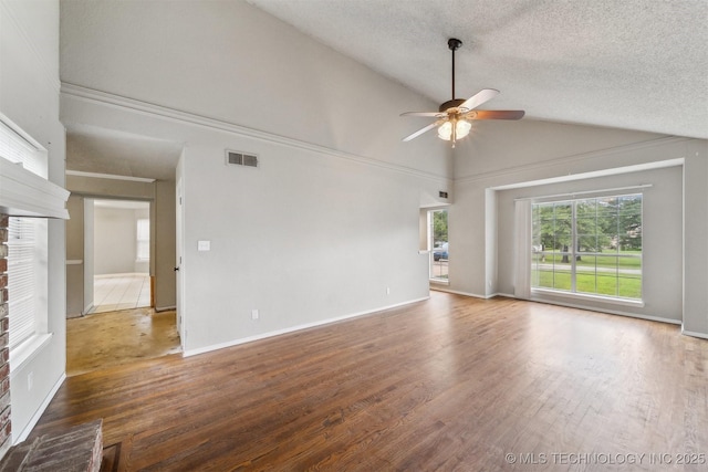 8973 N Crestwood Dr, Sperry, OK 74073 - unfurnished living room featuring ceiling fan, wood finished floors, a textured ceiling, high vaulted ceiling, and a brick fireplace