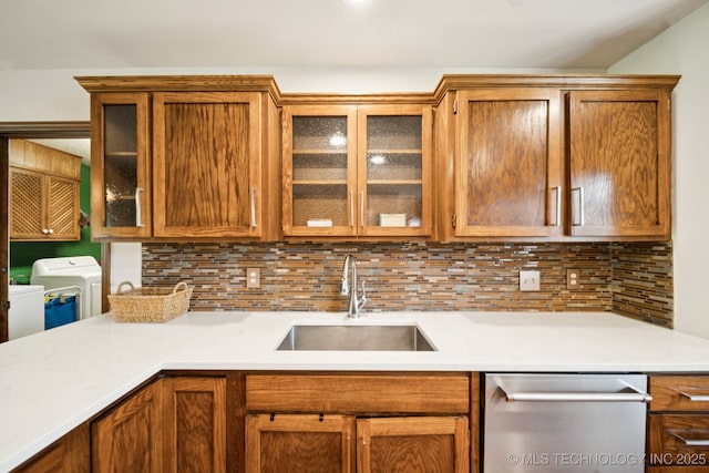 11783 S 252nd E Ave E, Broken Arrow, OK 74014 - kitchen featuring stainless steel dishwasher, washer and dryer, light countertops, decorative backsplash, and glass insert cabinets
