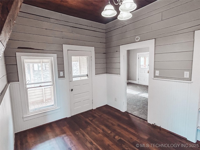 220 Belt Ave, Eufaula, OK 74432 - entryway with a chandelier, dark wood-style flooring, and wooden walls