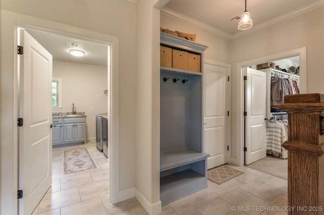 22322 E 121st St S, Broken Arrow, OK 74014 - mudroom with ornamental molding, washer and dryer, and light tile patterned floors