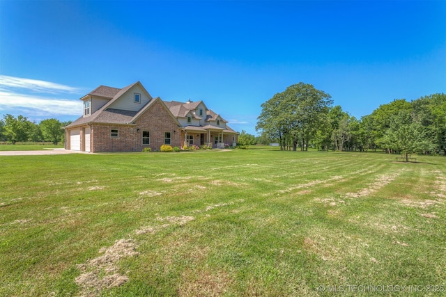 22322 E 121st St S, Broken Arrow, OK 74014 - view of grassy yard with a garage and concrete driveway