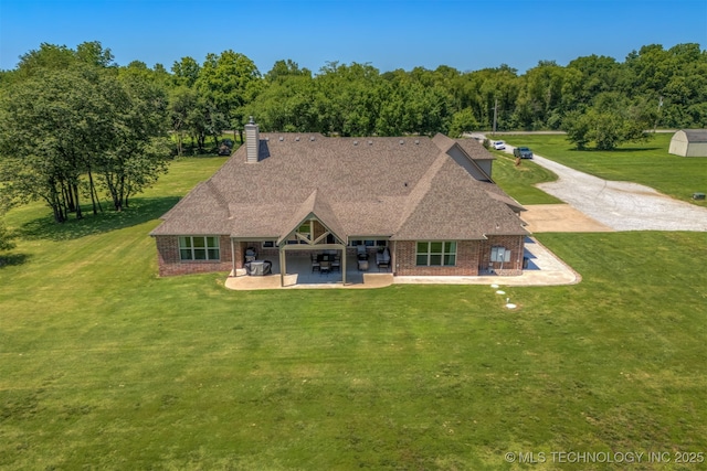 22322 E 121st St S, Broken Arrow, OK 74014 - rear view of house featuring a patio, a yard, a chimney, and brick siding
