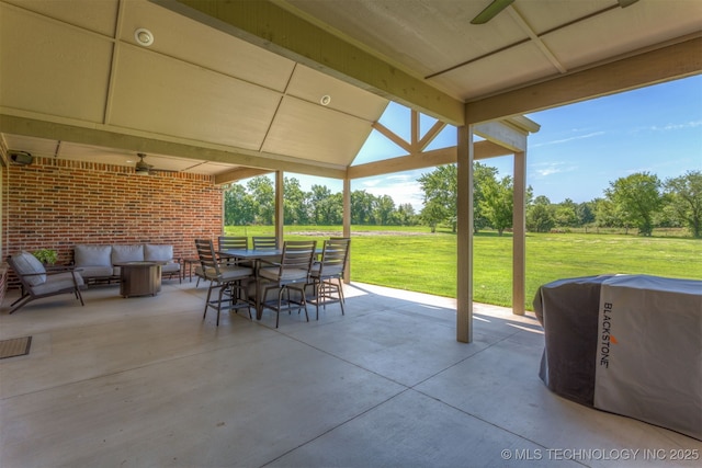 22322 E 121st St S, Broken Arrow, OK 74014 - view of patio / terrace featuring outdoor dining area, a ceiling fan, outdoor lounge area, and view of wooded area