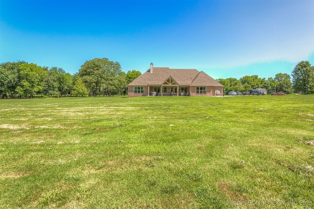 22322 E 121st St S, Broken Arrow, OK 74014 - rear view of house featuring a yard and a chimney