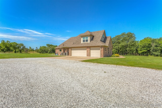 22322 E 121st St S, Broken Arrow, OK 74014 - view of side of home featuring gravel driveway, brick siding, and a yard