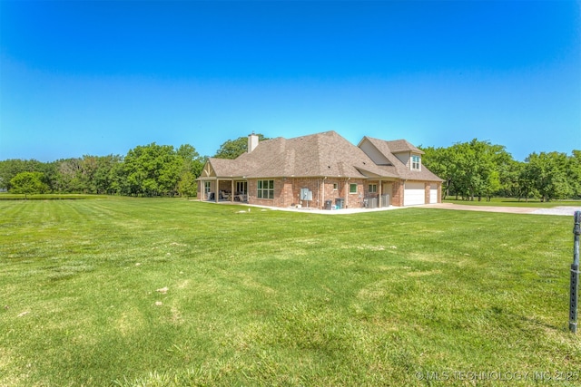 22322 E 121st St S, Broken Arrow, OK 74014 - view of front of property with concrete driveway, a front lawn, brick siding, and a chimney