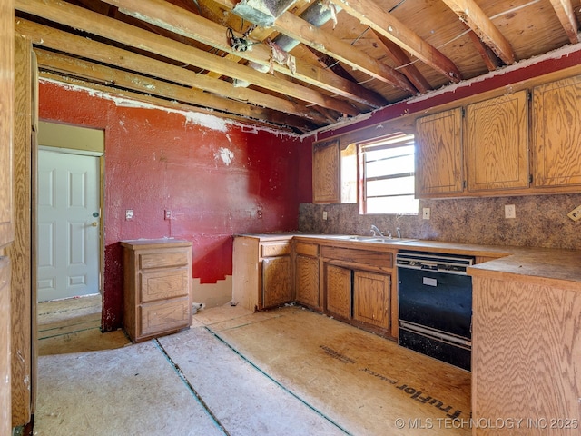 310 E Division, Roff, OK 74865 - kitchen with black dishwasher, brown cabinetry, and tasteful backsplash