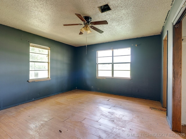 310 E Division, Roff, OK 74865 - empty room featuring a textured ceiling, a ceiling fan, and hardwood / wood-style floors