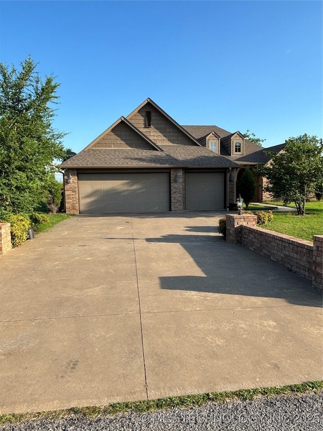6178 Fulham St, Claremore, OK 74019 - view of front of home featuring an attached garage, driveway, roof with shingles, and brick siding