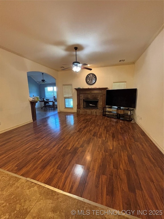 6178 Fulham St, Claremore, OK 74019 - unfurnished living room featuring a ceiling fan, wood finished floors, and a brick fireplace