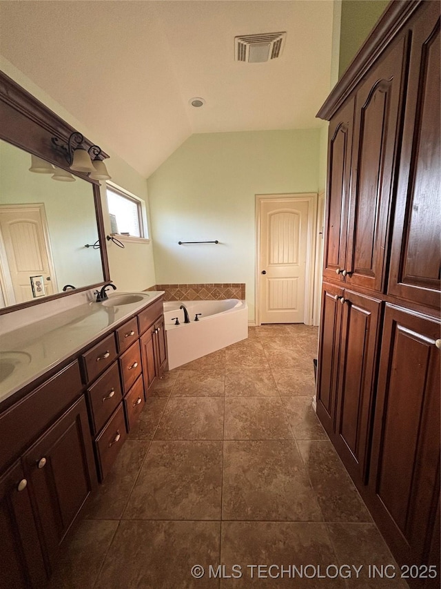 6178 Fulham St, Claremore, OK 74019 - bathroom featuring double vanity, a bath, and lofted ceiling
