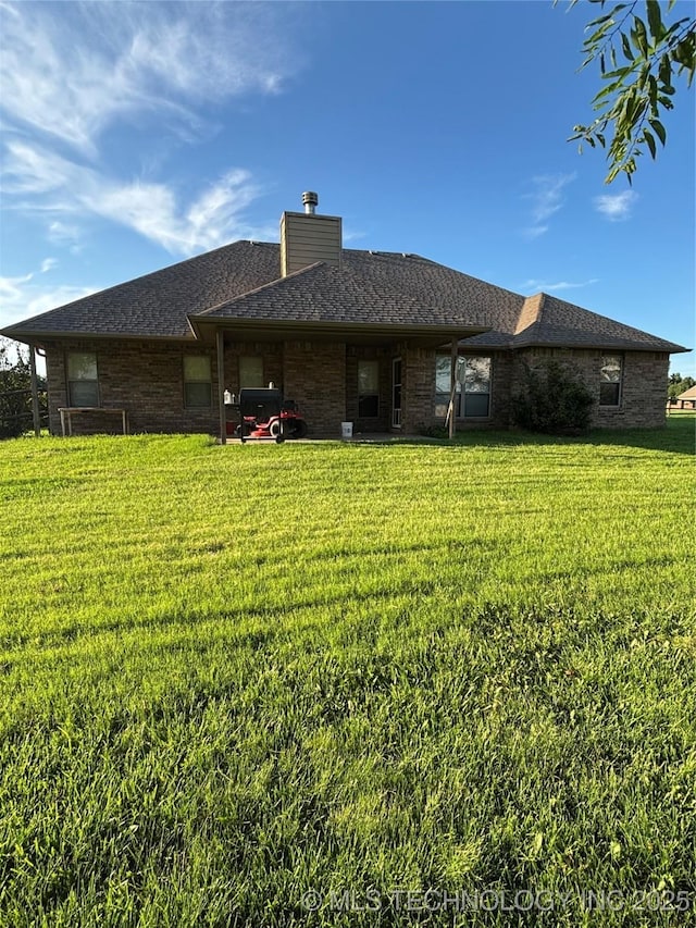 6178 Fulham St, Claremore, OK 74019 - rear view of property with a lawn and a chimney