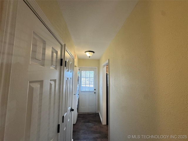 769 Terrace Dr, Prue, OK 74060 - doorway to outside featuring washer / clothes dryer, a textured wall, and dark wood-type flooring