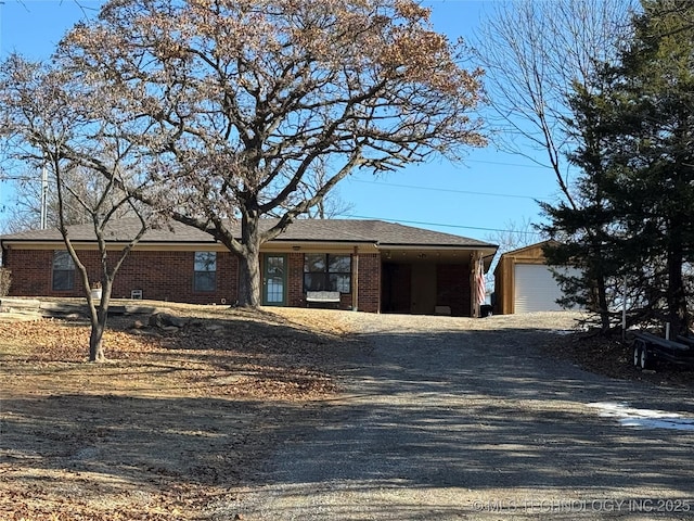 769 Terrace Dr, Prue, OK 74060 - ranch-style home featuring gravel driveway, brick siding, and a garage