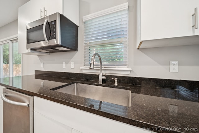 4534 E 5th Pl, Tulsa, OK 74112 - kitchen featuring stainless steel appliances, white cabinets, and dark stone countertops