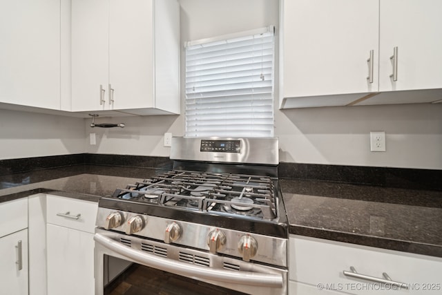 4534 E 5th Pl, Tulsa, OK 74112 - kitchen featuring stainless steel gas range oven, white cabinetry, and dark stone counters