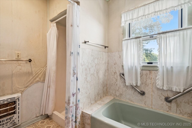 785 US Highway 60, Bartlesville, OK 74003 - bathroom featuring heating unit, a tub to relax in, a shower with shower curtain, and tile patterned floors